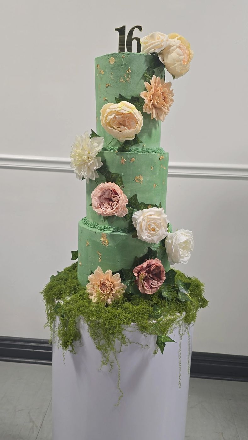 Three-tier green sweet sixteen cake with garden roses and moss