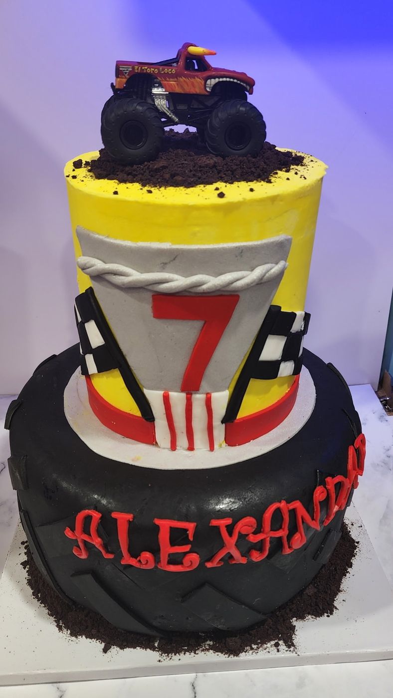 Monster truck birthday cake with a tire base and a fondant number 7